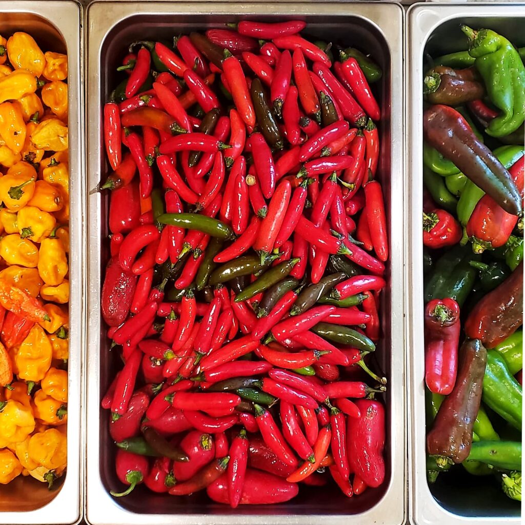 A tray of bright red spicy peppers.