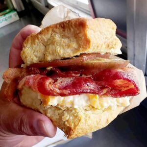 A biscuit sandwich with crispy bacon and sliced farm fresh tomato