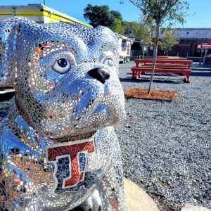An art installation of "Mirrored Image" by Jo L. Gates. It's a bulldog mascot covered in mosaic mirror pieces. It has the Louisiana Tech Logo on it's chest. Sponsored by Jeannette and Justin Hinckley.